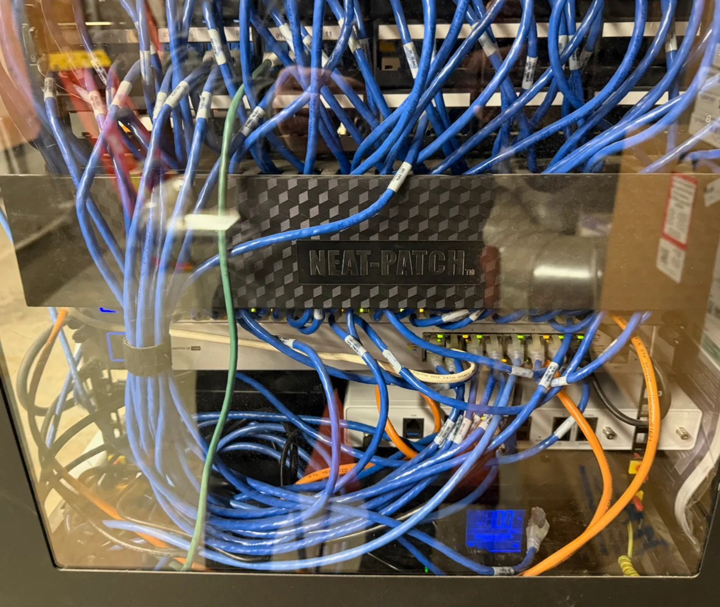 Before: cluttered business network rack with tangled cabling and difficult service access